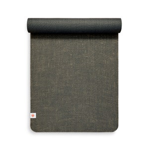 May include: A rolled up black yoga mat with a subtle textured surface. The mat has a small logo in the bottom left corner.