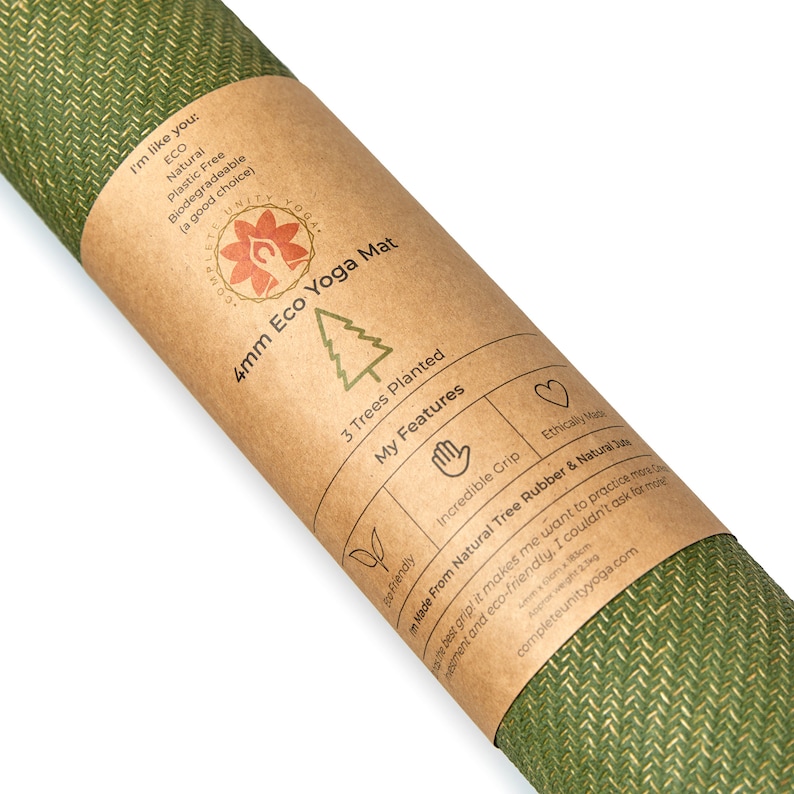 May include: A brown paper tube with a green yoga mat inside. The tube has a label that says "4mm Eco Yoga Mat" and lists features like "3 Trees Planted", "Incredible Grip", and "Made From Natural Tree Rubber & Natural Jute".