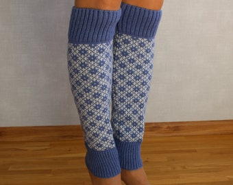 May include: A pair of blue and white patterned leg warmers. The leg warmers are knitted and have a blue cuff at the top.
