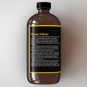 May include: A brown glass bottle with a black label that reads "Please follow: This is a very powerful Ormus. Ormus is all about intention. It can change your life in a positive manner and rewire your brain to get rid of your anxiety, doubts, and negative feelings. Life is a blessing and this Ormus will lead you to see that to its fullest."