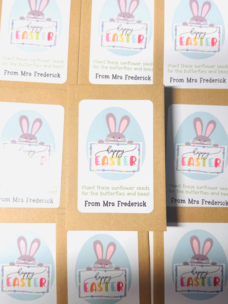 May include: Six brown paper seed packets with colourful bunny illustrations and the text "Happy Easter" on each. The packets have instructions to plant the seeds for butterflies and bees. Each packet is signed "From Mrs Frederick."