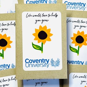 May include: A brown paper packet with a white sticker that says "Coventry University" and features a sunflower and the text "We would love to help you grow".