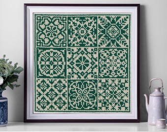 May include: Framed cross-stitch artwork featuring a grid of nine geometric patterns in shades of green and cream. The artwork is displayed in a dark brown frame with a white mat, creating a striking contrast. The piece is a decorative home accent.