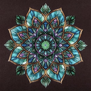 Puede incluir: Diseño de mandala simétrico y detallado en tonos turquesa, azul, verde y morado, con detalles dorados. La obra presenta patrones intrincados y un motivo floral central, sobre un fondo marrón oscuro.