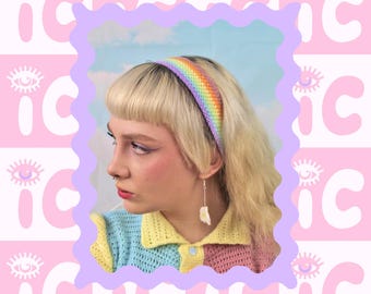 May include: A rainbow crochet headband with a light purple background. The text "PRIDE RAINBOW HEADBAND" and "EASY PATTERN" is displayed on the image.