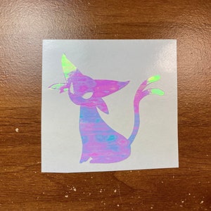 May include: A holographic sticker of a purple and blue cat with a green tail and a green horn on its head.