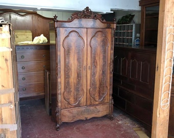 Antique French hardwood armoire with carved crest 1900s