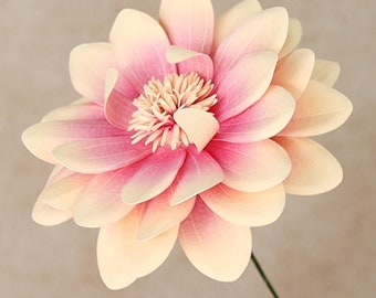 May include: A large, paper flower with delicate, layered petals in shades of pink and cream. The flower is crafted with intricate details and has a soft, romantic aesthetic.