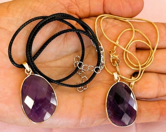 May include: Two necklaces with amethyst pendants. One necklace has a black cord and the other has a gold chain.
