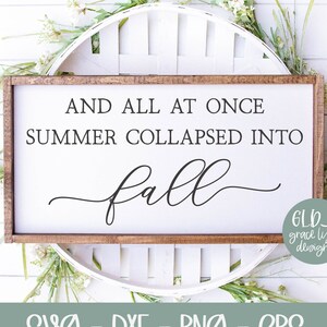 May include: A wooden sign with the text "AND ALL AT ONCE SUMMER COLLAPSED INTO fall" in black lettering. The sign is surrounded by white flowers and a white wooden background.