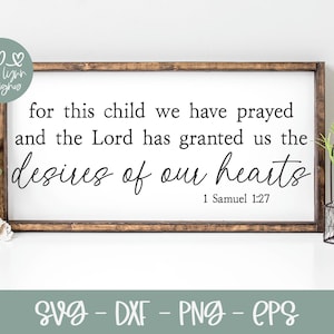 May include: A wooden sign with a white background and brown frame. The sign features a Bible verse from 1 Samuel 1:27, which reads "for this child we have prayed and the Lord has granted us the desires of our hearts".