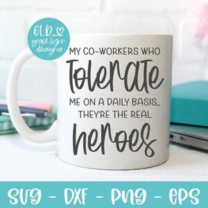 May include: White ceramic mug with black text that reads "My co-workers who tolerate me on a daily basis... They're the real heroes".