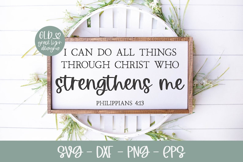 May include: A white sign with a wood frame, featuring the text "I can do all things through Christ who strengthens me" with the scripture reference "Philippians 4:13".