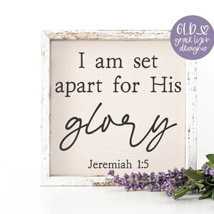 May include: A white wooden sign with the text "I am set apart for His glory" and the scripture reference "Jeremiah 1:5".