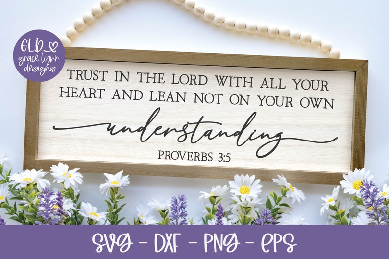 May include: A wooden sign with the text "TRUST IN THE LORD WITH ALL YOUR HEART AND LEAN NOT ON YOUR OWN understanding PROVERBS 3:5" in black lettering. The sign is surrounded by white and purple flowers.