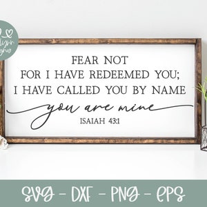 May include: A white wooden sign with a brown frame, featuring the text "Fear not, for I have redeemed you; I have called you by name you are mine, Isaiah 43:1".