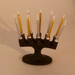 A  miniature Robert Welsh cast iron candelabra