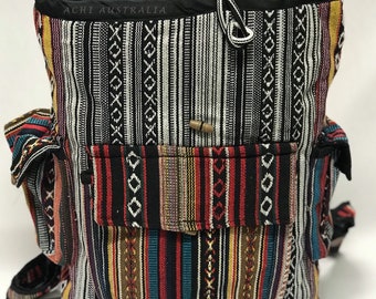May include: A multi-colored striped backpack with a black drawstring top and a small pocket on the front. The backpack has the text "ACHI AUSTRALIA" on the top.
