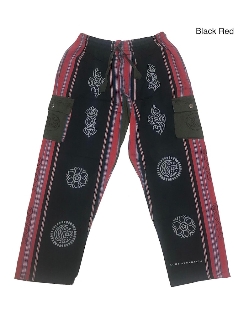 May include: Black and red striped pants with a green cargo pocket on each side. The pants have a drawstring waist and are decorated with white patterned circles.