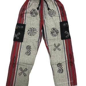 May include: Grey and maroon striped pants with black and white patterned designs and two black pockets. The pants have a drawstring waist.