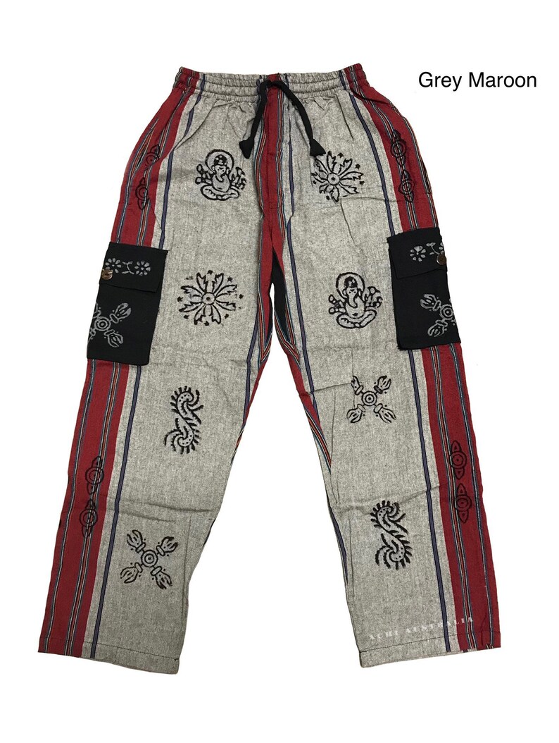 May include: Grey and maroon striped pants with black and white patterned designs and two black pockets. The pants have a drawstring waist.