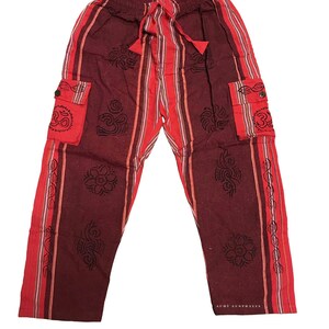 May include: Maroon red striped pants with black Om symbol designs and side pockets. The pants have a drawstring waist.