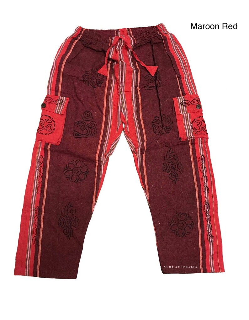 May include: Maroon red striped pants with black Om symbol designs and side pockets. The pants have a drawstring waist.