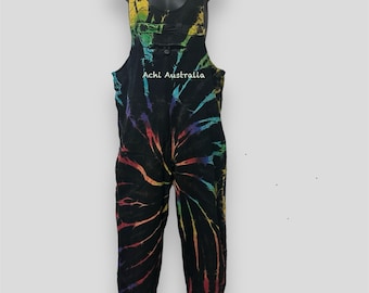 May include: Black tie-dye overalls with a rainbow spiral design. The straps and upper chest area feature a vibrant rainbow pattern. The text "Achi Australia" is printed on the garment. The overalls are displayed on a black mannequin.