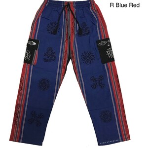 May include: Blue and red striped pants with black patterned designs. The pants have two black pockets with a silver eye design. The text "R Blue Red" is in the upper right corner of the image. The text "ACHI AUSTRALIA" is on the bottom right leg of the pants.