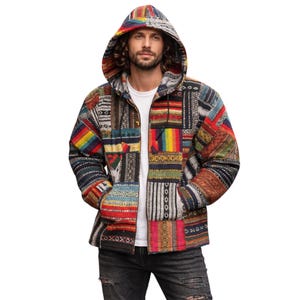 May include: A colourful patchwork jacket with a hood, zip closure, and pockets. The jacket's design incorporates a variety of patterns and textures, including a rainbow stripe. The jacket is worn over a white t-shirt and dark jeans. The jacket is a unique piece of clothing.