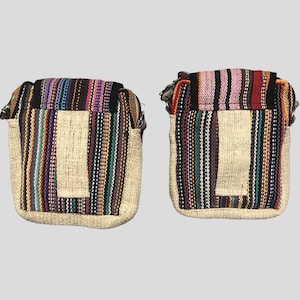 May include: Two small, rectangular, striped hemp bags with zipper closures. The bags have a small pocket on the front and are made of natural hemp fabric with colourful stripes.