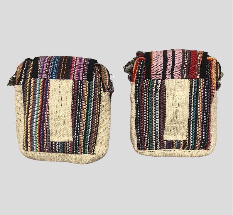 May include: Two small, rectangular, striped hemp bags with zipper closures. The bags have a small pocket on the front and are made of natural hemp fabric with colourful stripes.