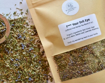 May include: A brown paper bag with a clear window showing a blend of dried herbs. The bag has a white label that reads "F*** Your Evil Eye Caffeine Free Herbal Tea Blend (1 oz) Organic Ingredients: Red Clover, Sage St. John's Wort, Nettle Leaf, Lavender, Rosemary From my wandering heart to your hands."