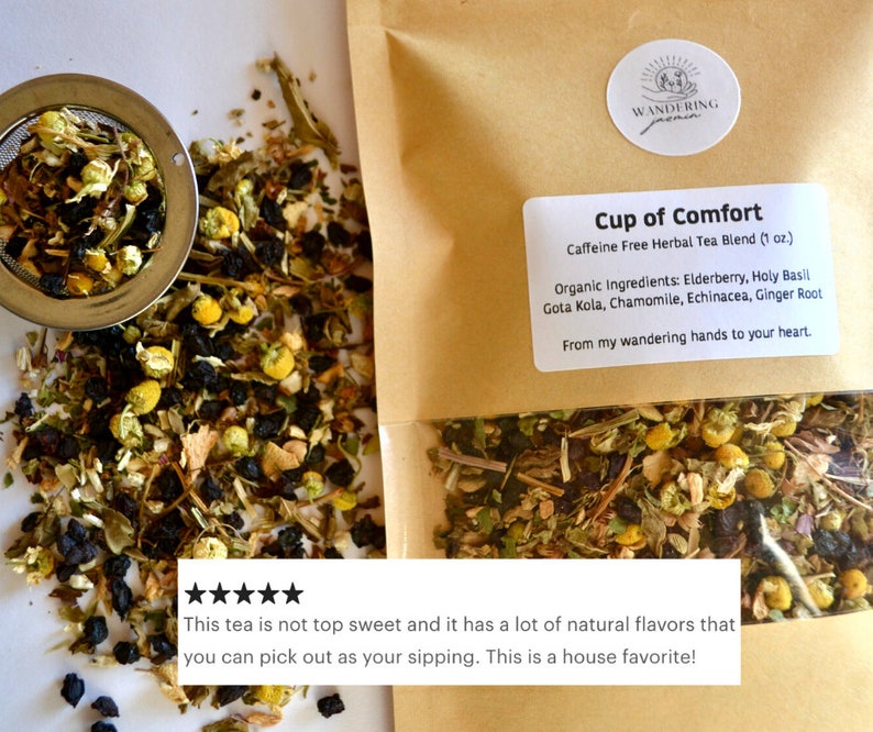 May include: A brown paper bag with a label that reads "Cup of Comfort Caffeine Free Herbal Tea Blend (1 oz.)" and lists the ingredients: Elderberry, Holy Basil, Gota Kola, Chamomile, Echinacea, Ginger Root. The bag contains a blend of dried herbs and flowers. The text "From my wandering hands to your heart." is also on the label. A five-star review reads: "This tea is not too sweet and it has a lot of natural flavours that you can pick out as you sip it. This is a house favourite!"