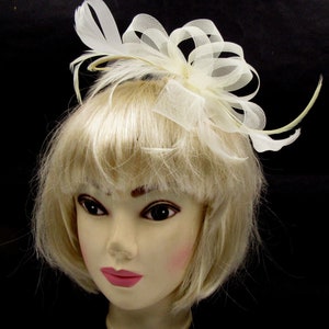 Looped cream net and feather fascinator comb weddings races prom