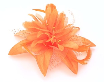 Orange flower and feather fascinator comb ,weddings, races ,prom ladies day