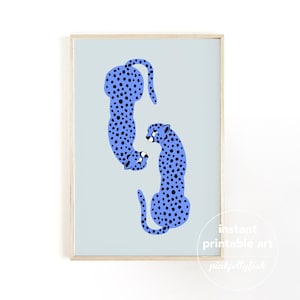 May include: A framed print showing two blue cheetahs with black spots against a pale blue backdrop. The artwork is minimalist and includes the text "instant printable art" and "pinkjellyfish".