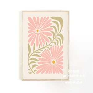 May include: A framed floral print featuring two large pink daisy-like flowers with yellow centers and olive green leaves on a cream background. The print is labeled "instant printable art" and "pinkjellyfish".