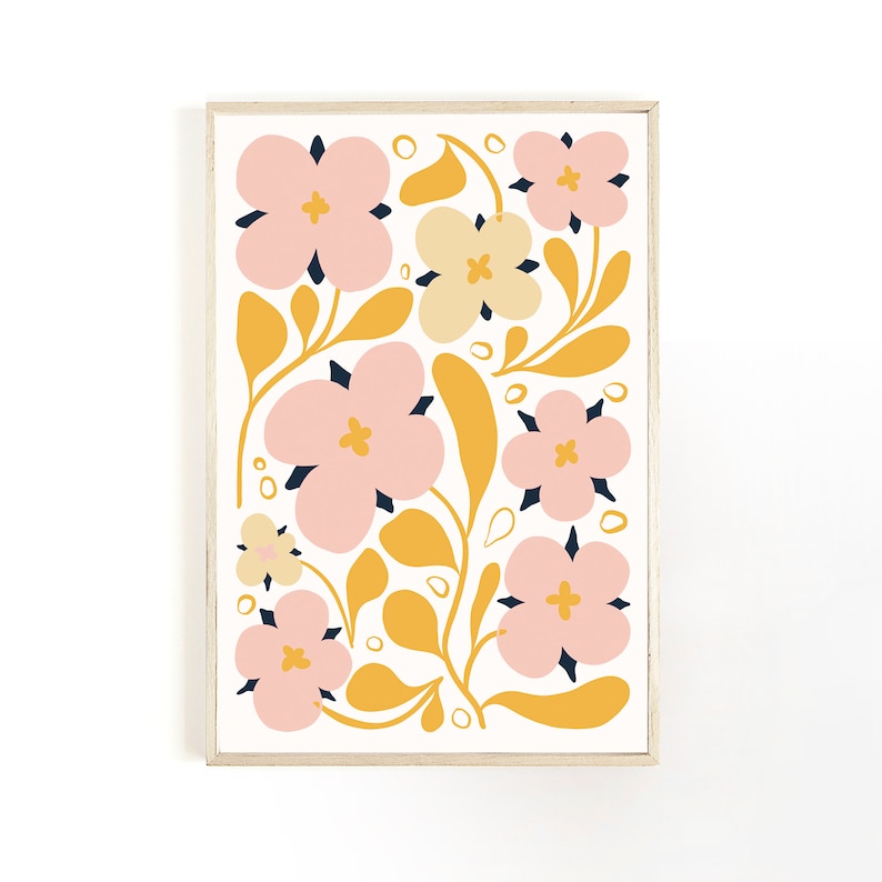 May include: A framed floral art print featuring a repeating pattern of stylized flowers and leaves. The flowers are primarily pink with dark blue centers and yellow accents. The leaves and stems are yellow against a white background.