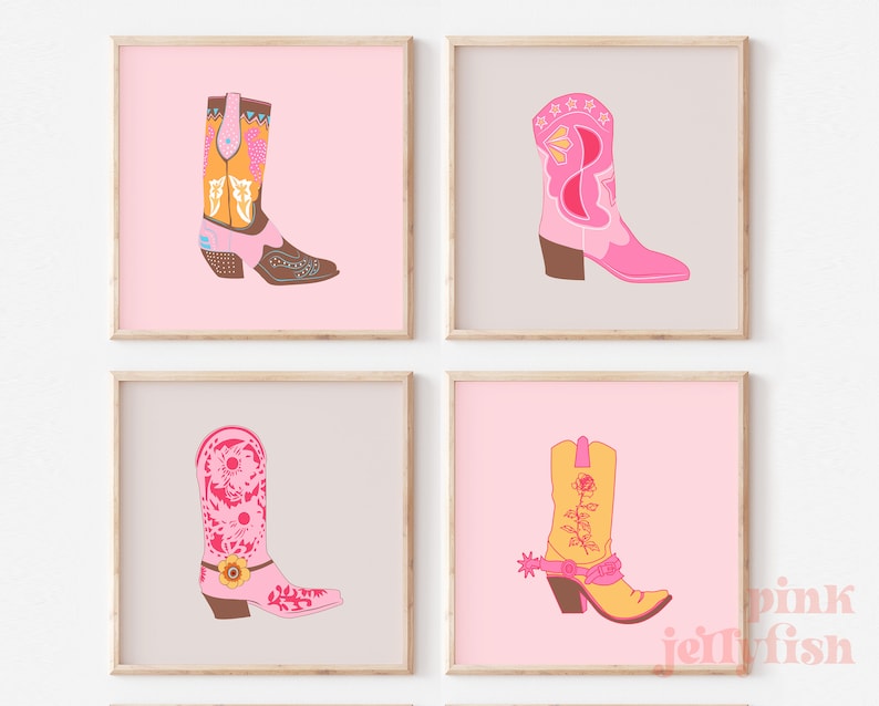 May include: Set of four printable art prints featuring pink, yellow, and brown cowboy boots with floral and geometric designs. The prints have a pink background and are framed in a light wood frame.