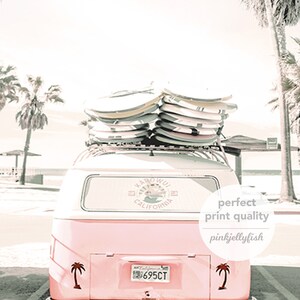 May include: A pink vintage van with surfboards on the roof. The van has a sticker on the back window that says "Kamo'oal  California". The van has a license plate that says "695CT".