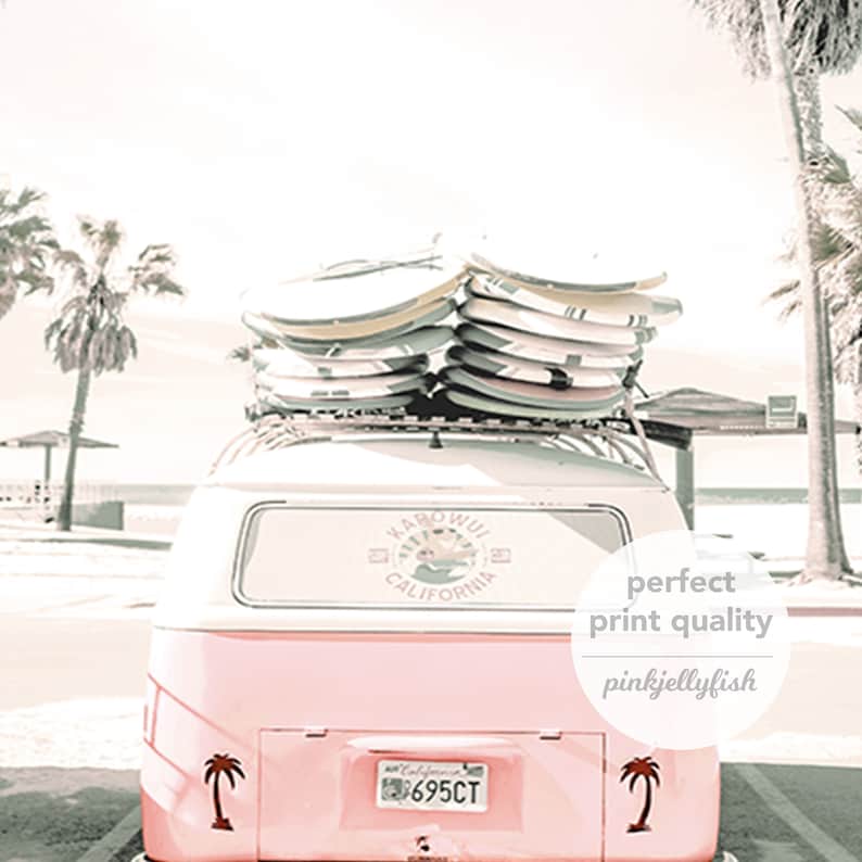 May include: A pink vintage van with surfboards on the roof. The van has a sticker on the back window that says "Kamo'oal  California". The van has a license plate that says "695CT".