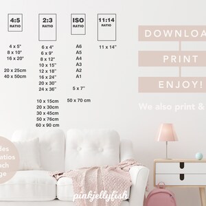 May include: A white couch with a pink throw blanket in a room with a white wall. The wall has a list of different print sizes and ratios for downloadable digital art prints. The text on the wall reads "Download, Print, Enjoy! We also print & ship".