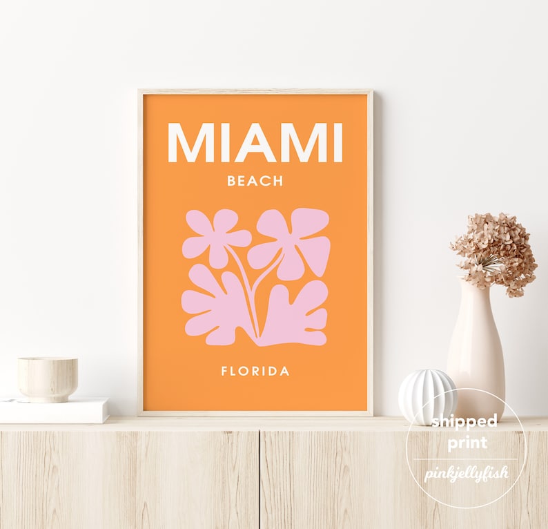 May include: Orange and pink abstract art print with the text "Miami Beach, Florida".