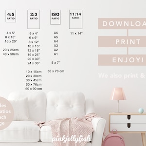 May include: A white couch with a pink throw blanket in a room with a pink lamp and a pink backpack. The wall has a chart with different aspect ratios and sizes for printing images. The text on the chart says "Download, Print, Enjoy! We also print & ship".