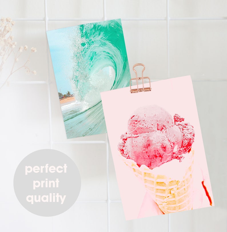 May include: Two prints, one with a turquoise wave crashing on a beach and the other with a pink ice cream cone on a light pink background.