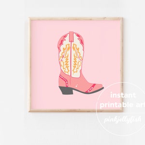 May include: Pink cowboy boot with yellow and white stitching on a pink background. The text "instant printable art" and "pinkjellyfish" is below the boot.
