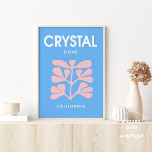 May include: A blue and pink minimalist art print with the text "CRYSTAL COVE CALIFORNIA".