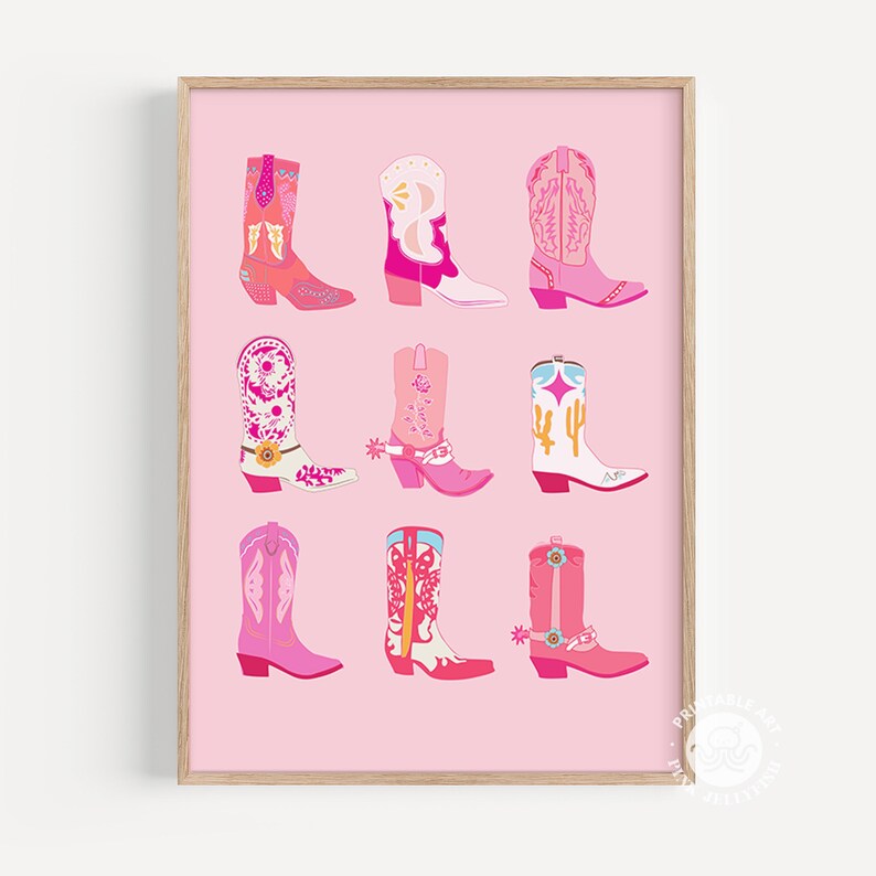 May include: A framed print featuring nine colorful cowboy boots in shades of pink, red, and white. The boots have various designs, including floral patterns, stars, and cactus motifs. The background is a solid light pink color.