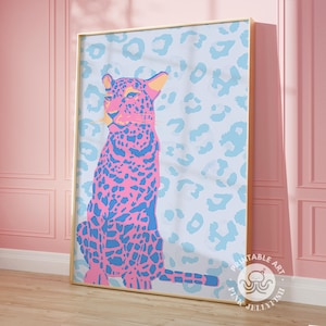 May include: A pink and blue leopard print design with a pink leopard sitting on a blue background. The design is framed in gold and has the text "Printable Art Pink Jellyfish" in the bottom right corner.
